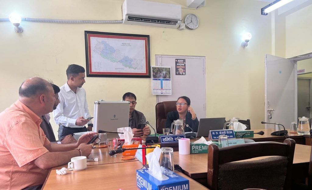 Representatives from Aarogya Nepal Tech showcasing the Praana health device to Hon. Dr. Ojashwee Sherchan in a meeting room.